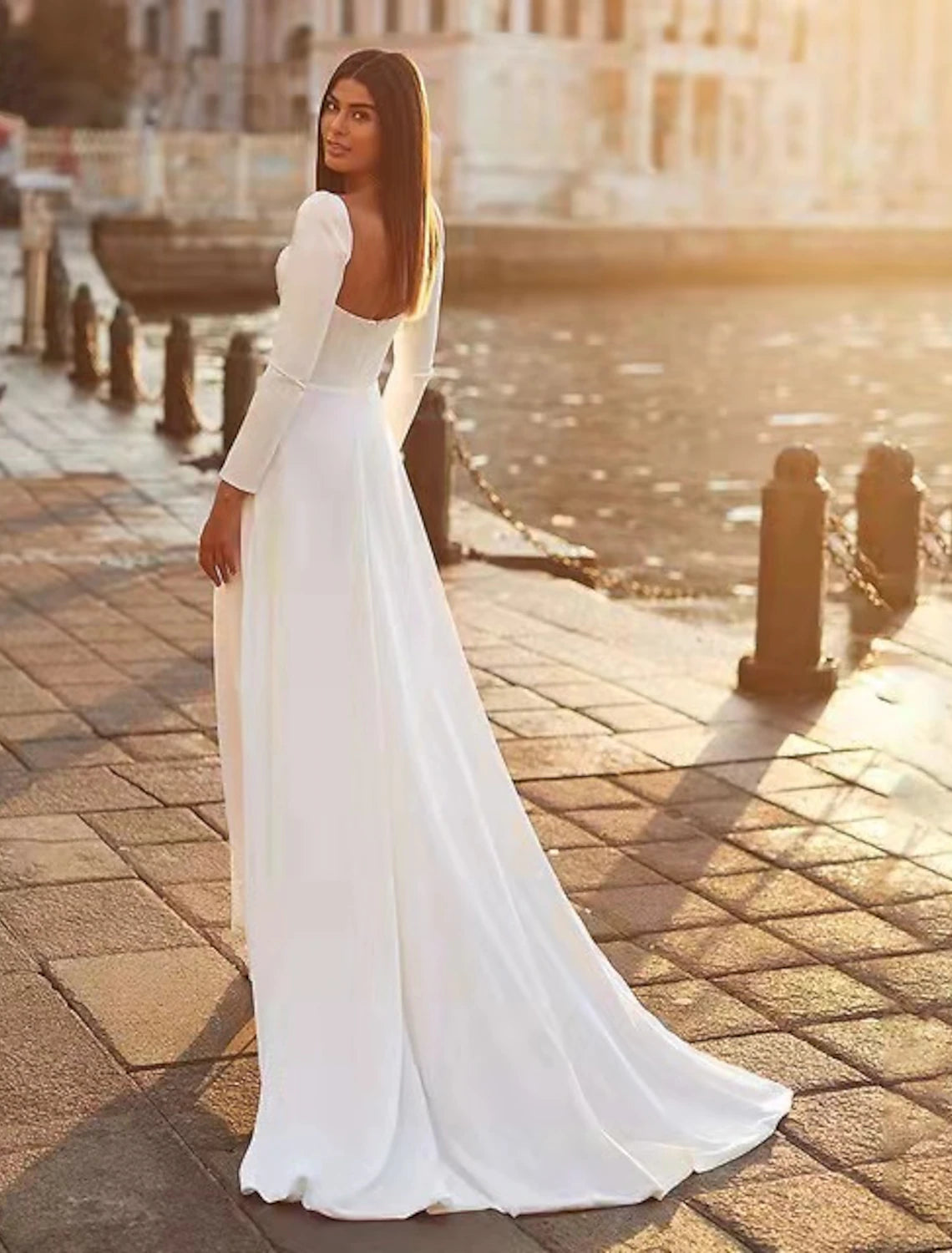 Close-up of the sweetheart neckline and long satin sleeves.