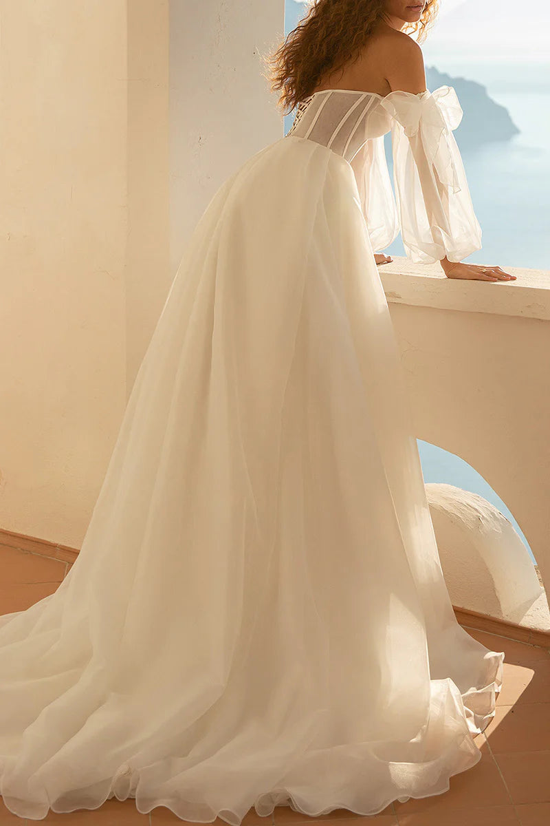 Back view of the A-line wedding dress, showcasing the long sleeves and flowing skirt.