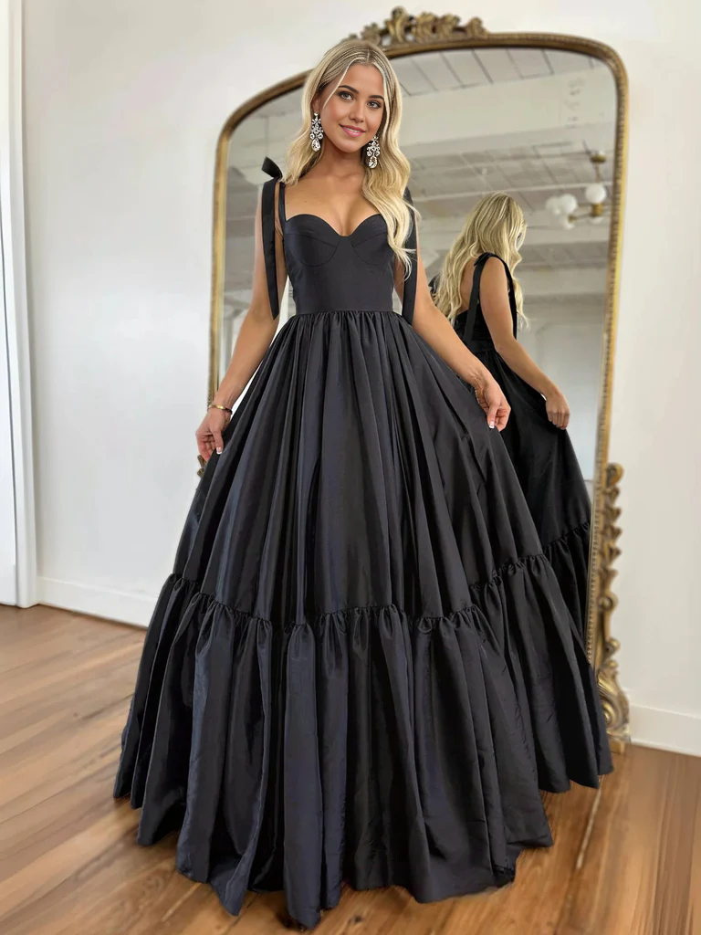 Woman wearing an elegant A-line sweetheart neck long formal evening dress.