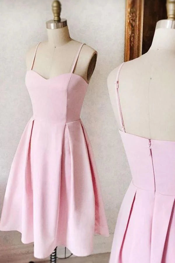 Model wearing a pink sweetheart neck short satin A-line homecoming dress, posing elegantly.