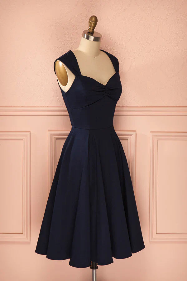 Model posing in a short A-line satin homecoming dress.