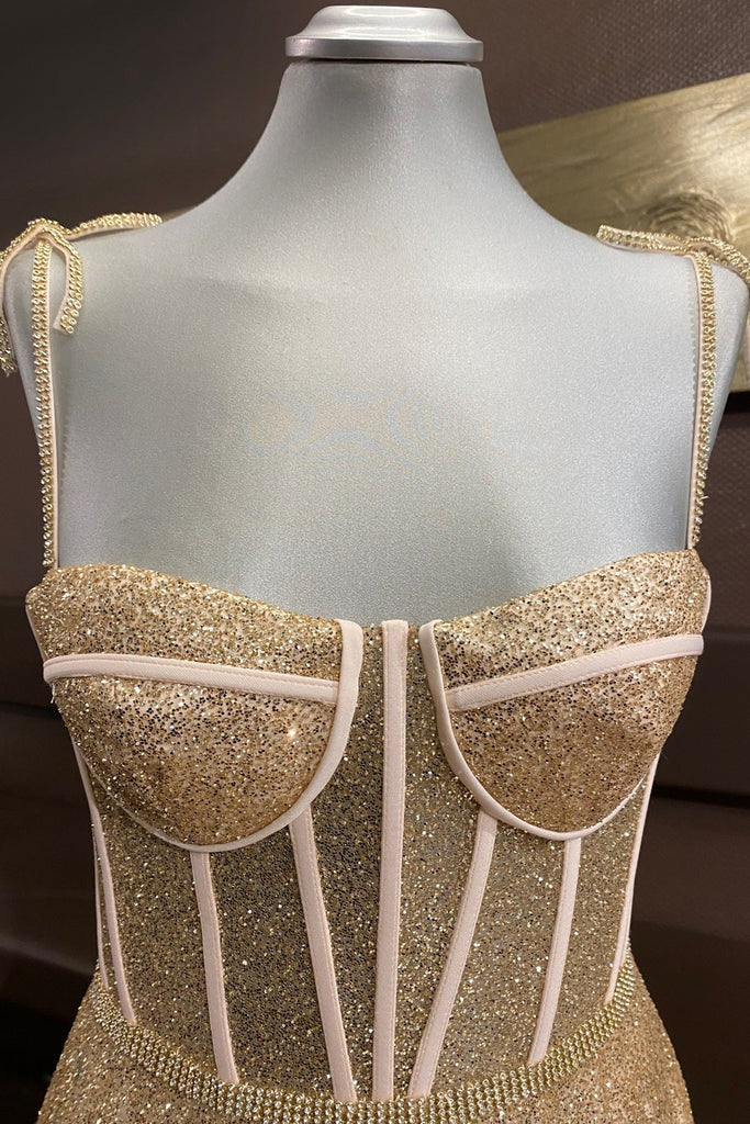 Back view of an elegant A-line prom dress with spaghetti straps.
