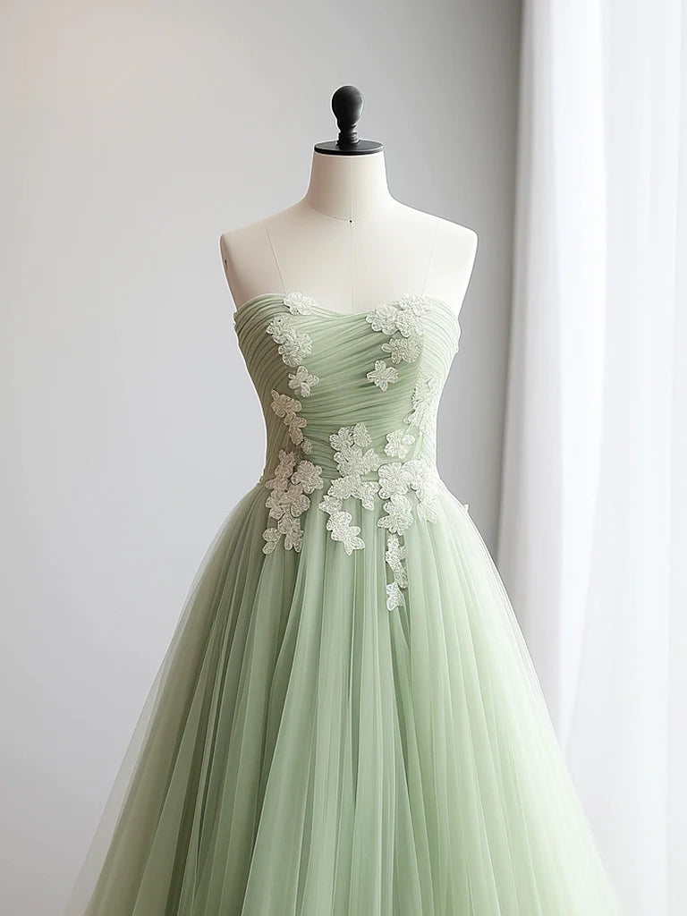 Long green evening gown featuring a sweetheart neck and delicate tulle fabric.
