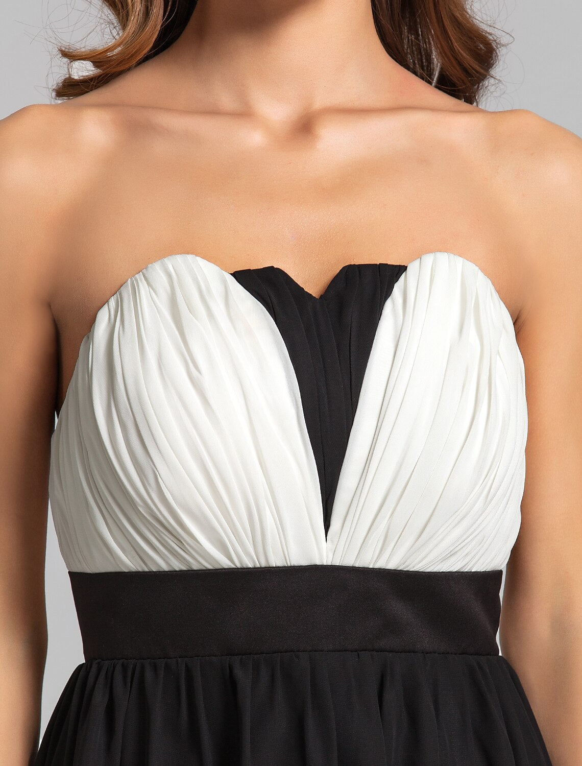Model posing gracefully in the knee-length A-line formal dress.