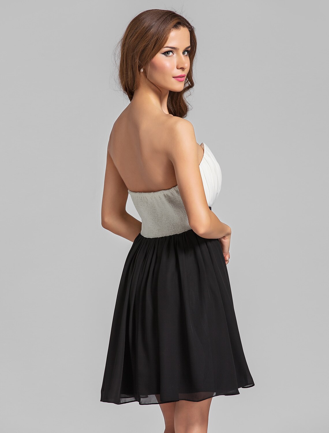 Close-up of the knee-length hem and flowing skirt of the chiffon dress.