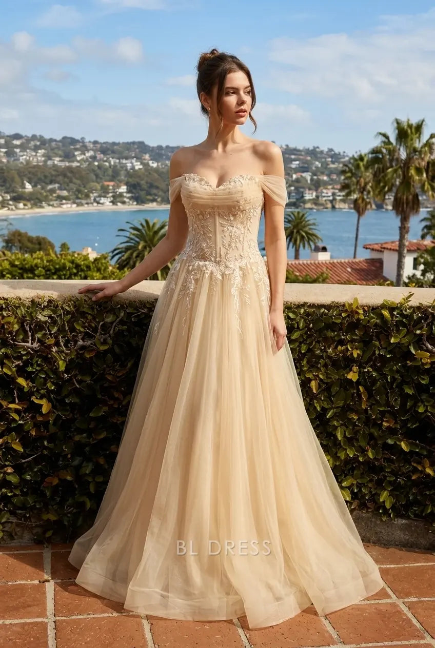 Close-up of intricate embroidered lace bodice and sweetheart neckline on champagne gown.