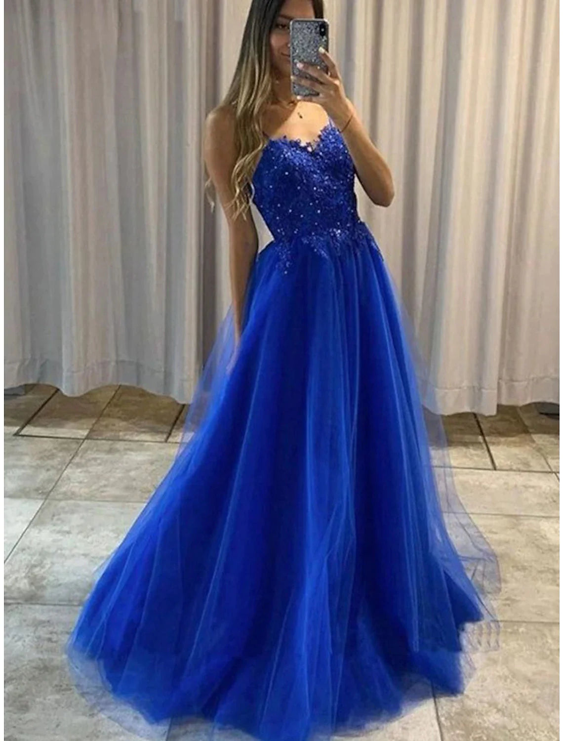 Elegant A-Line sweetheart prom dress with intricate beading and appliques.