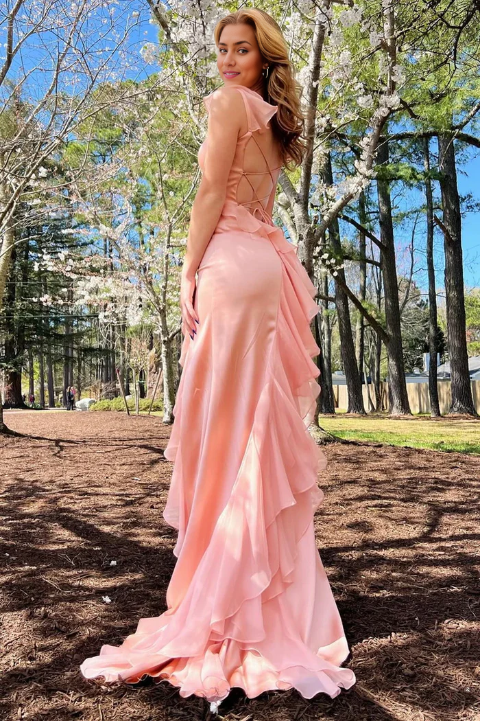 Side view of a woman in an elegant maxi dress with a high slit.