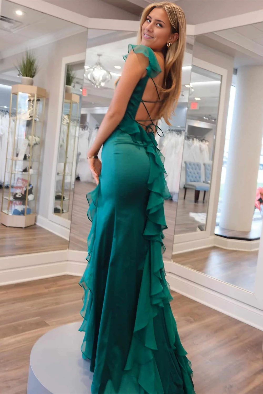 Woman showcasing the design of the A-line ruffle slit dress.