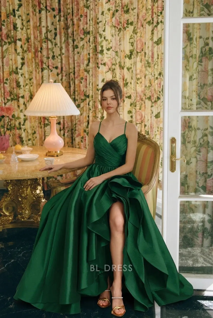Model in emerald green A-line prom gown with sweetheart neckline and ruffled high-low hem.