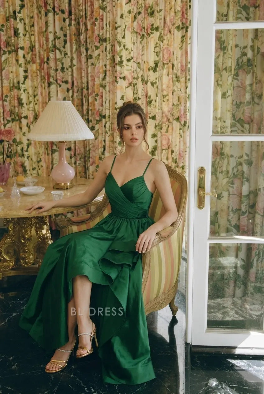 Close-up of sweetheart neckline and ruched bodice on emerald green prom dress.