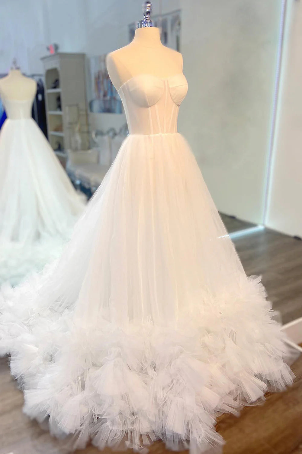 Full-length view of a sweetheart A-line prom gown featuring delicate ruffles.