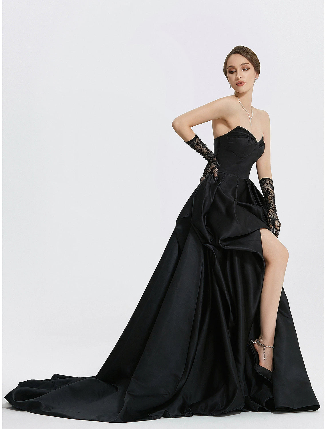 Side view of the elegant navy blue satin gown, highlighting the ruched slit detail.