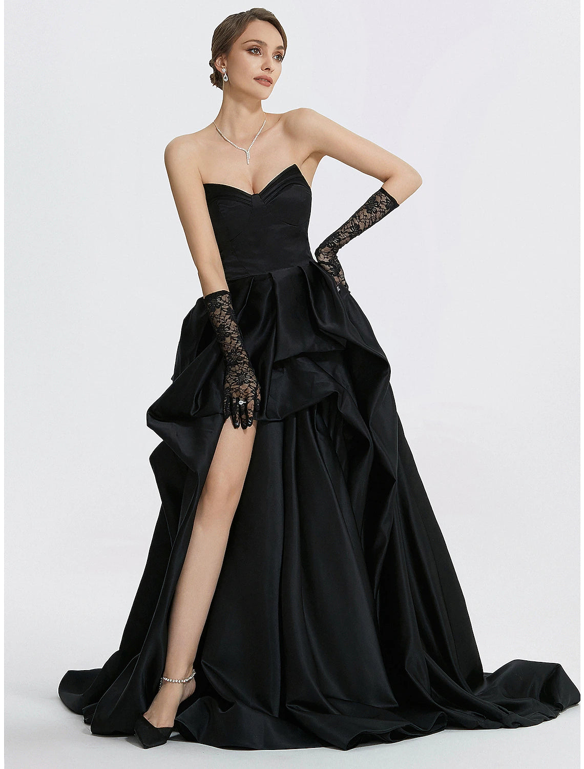 Close-up of the sweetheart neckline and satin fabric of the navy blue evening dress.