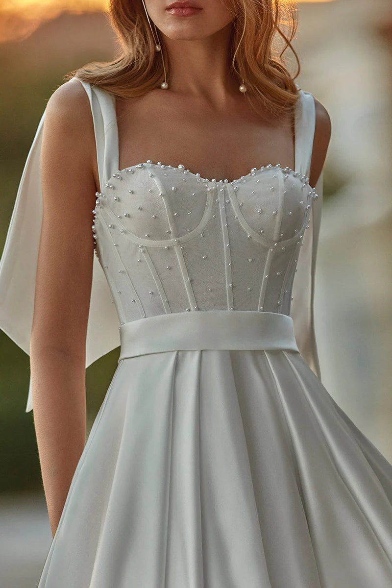 Close-up of luxurious satin fabric on a wedding dress.