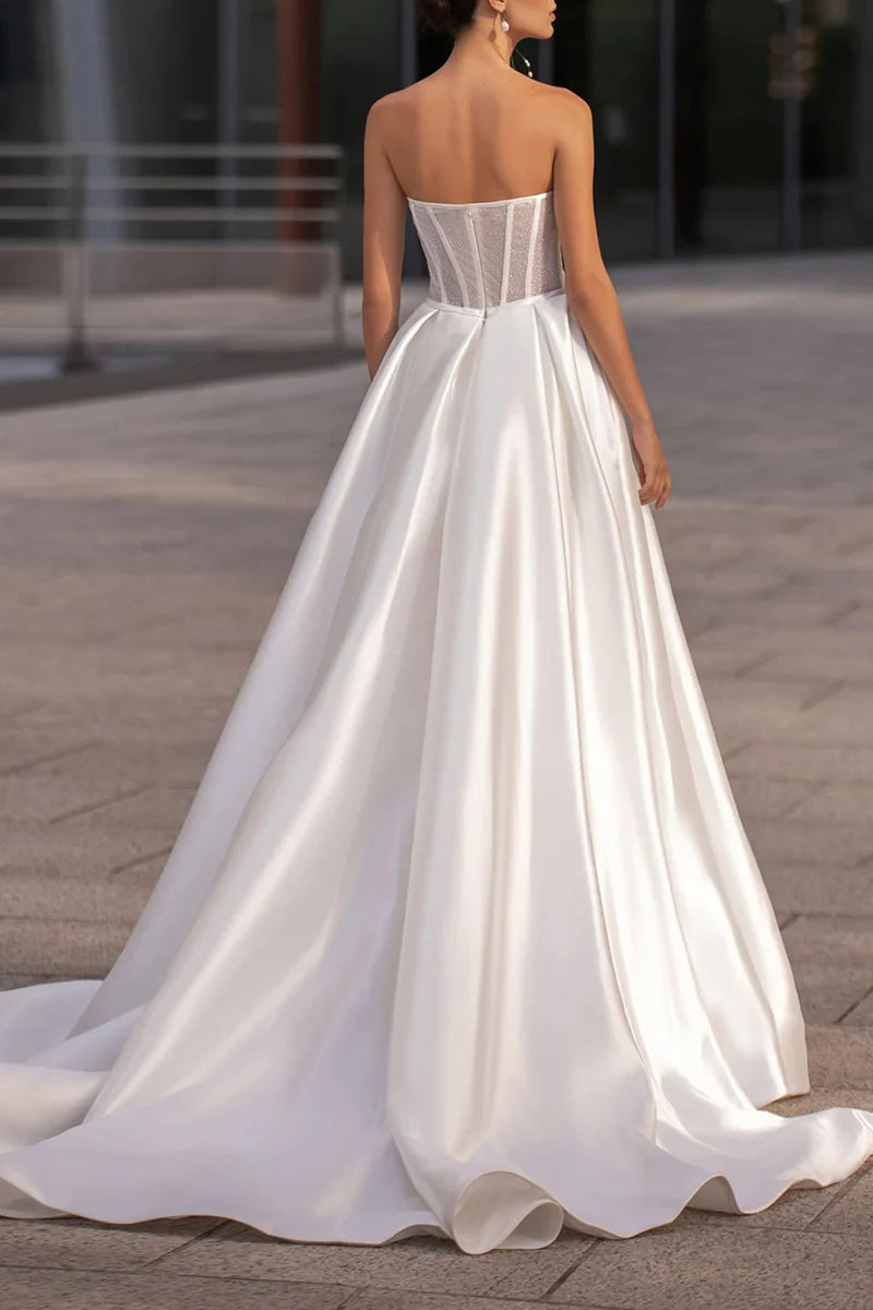 Bride in A-line sweetheart satin wedding dress, side view.