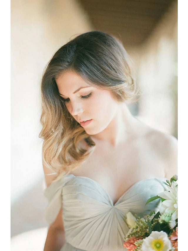 Close-up of the sweetheart neckline and pleats on the bridesmaid dress.
