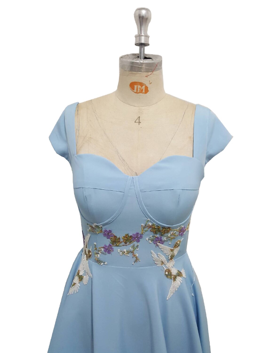 Close-up of the appliques on the elegant A-line gown's bodice.