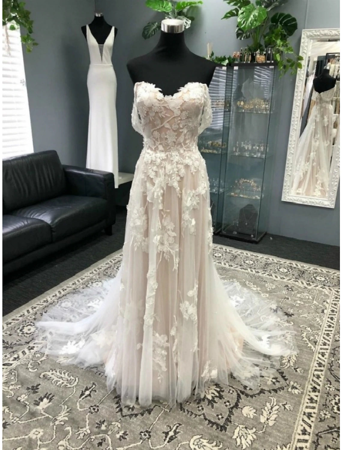 Elegant A-line sweetheart wedding dress with short sleeves, lace appliques, and a court train.