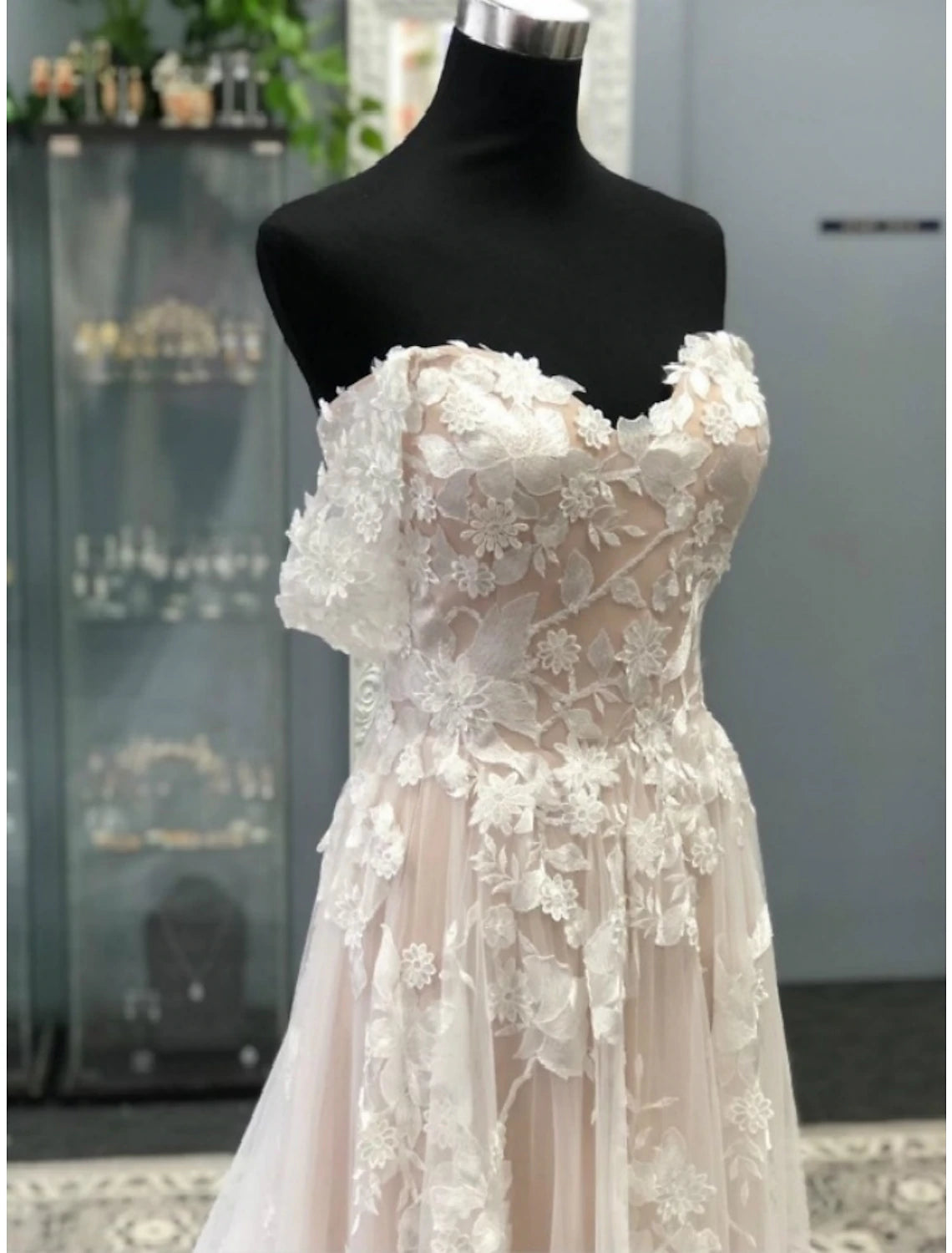 Close-up of lace appliques and pleats on a beach formal bridal gown.