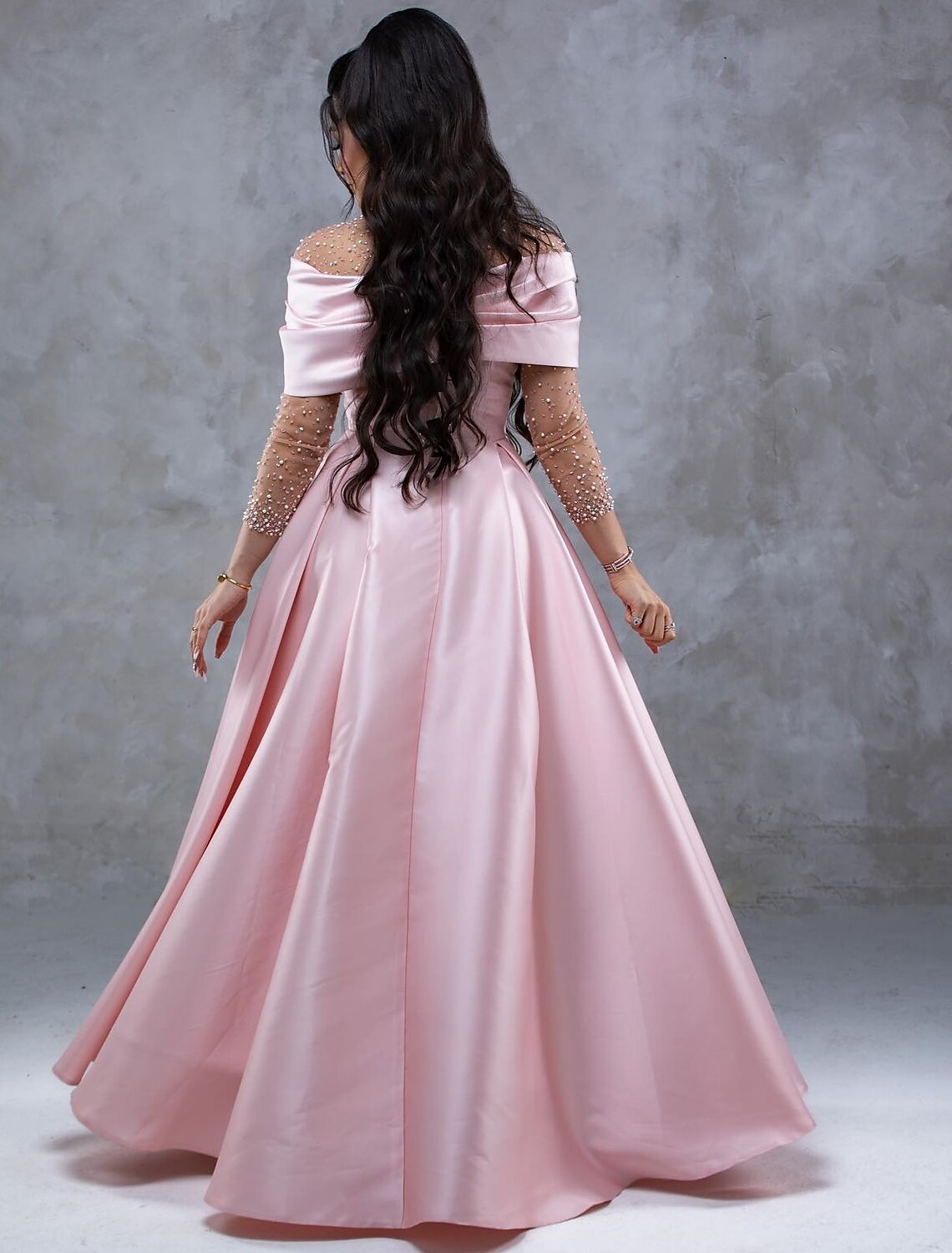 Back view of A-Line satin gown showing floor-length skirt and ruched details.