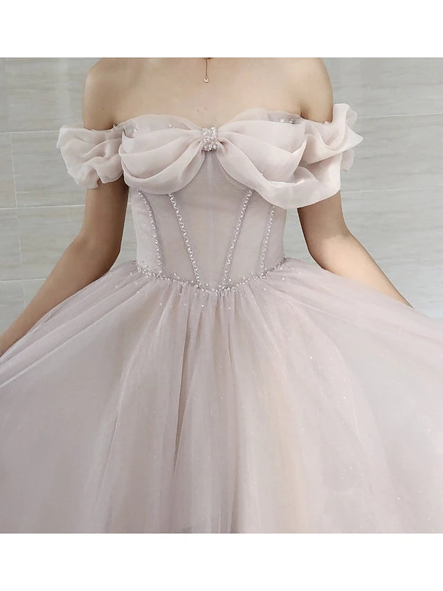 Back view of the A-line prom dress showing the sweep train and pleats.
