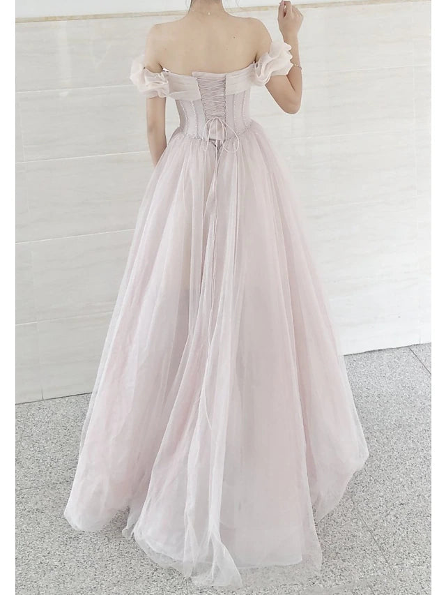 Side view of the model in the short sleeve tulle prom dress.