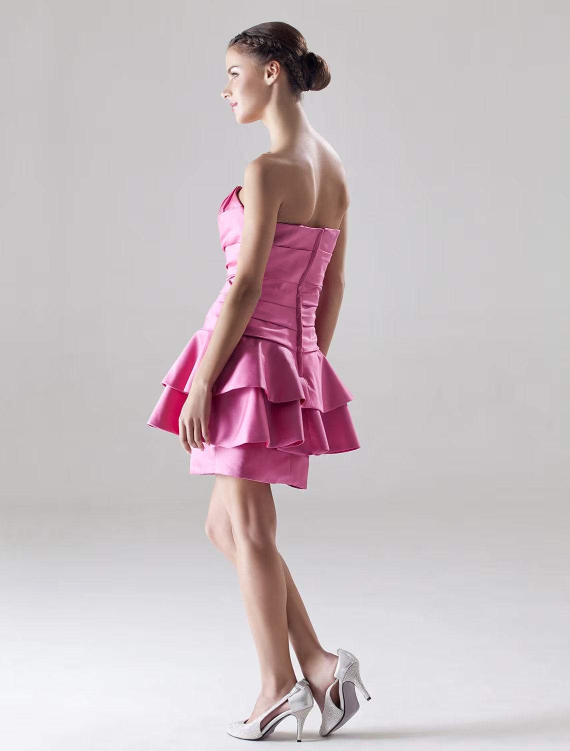 Close-up of the sweetheart neckline and draped detail on the satin dress.