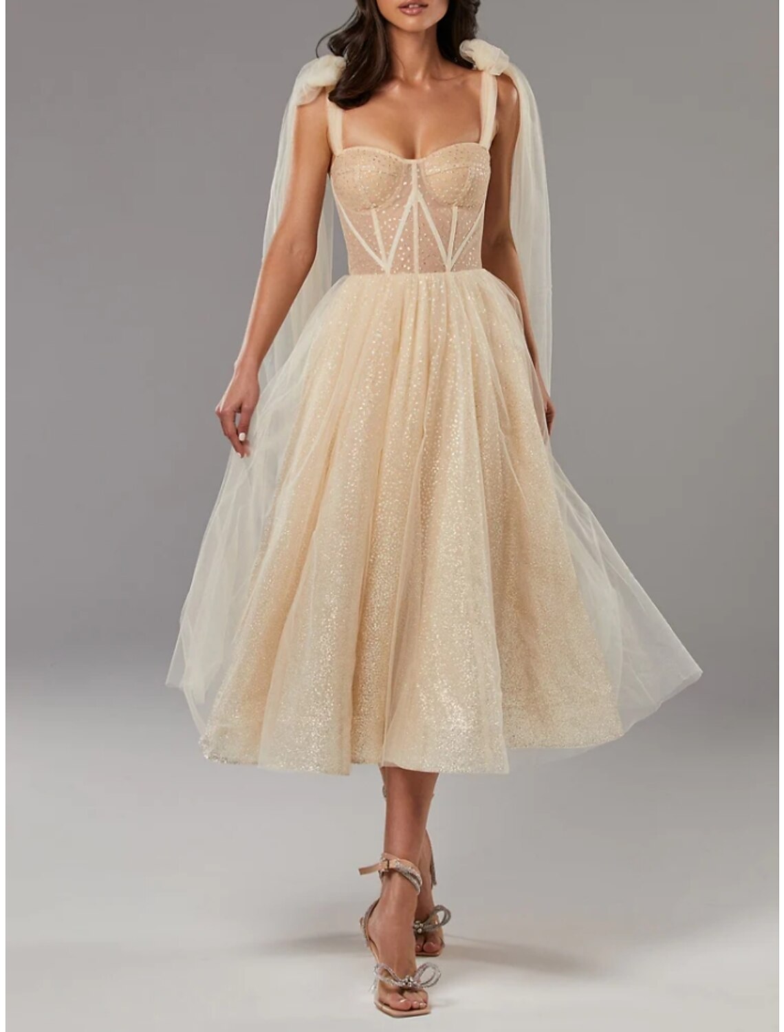 Back view of a tea-length A-line formal dress with pleated tulle.