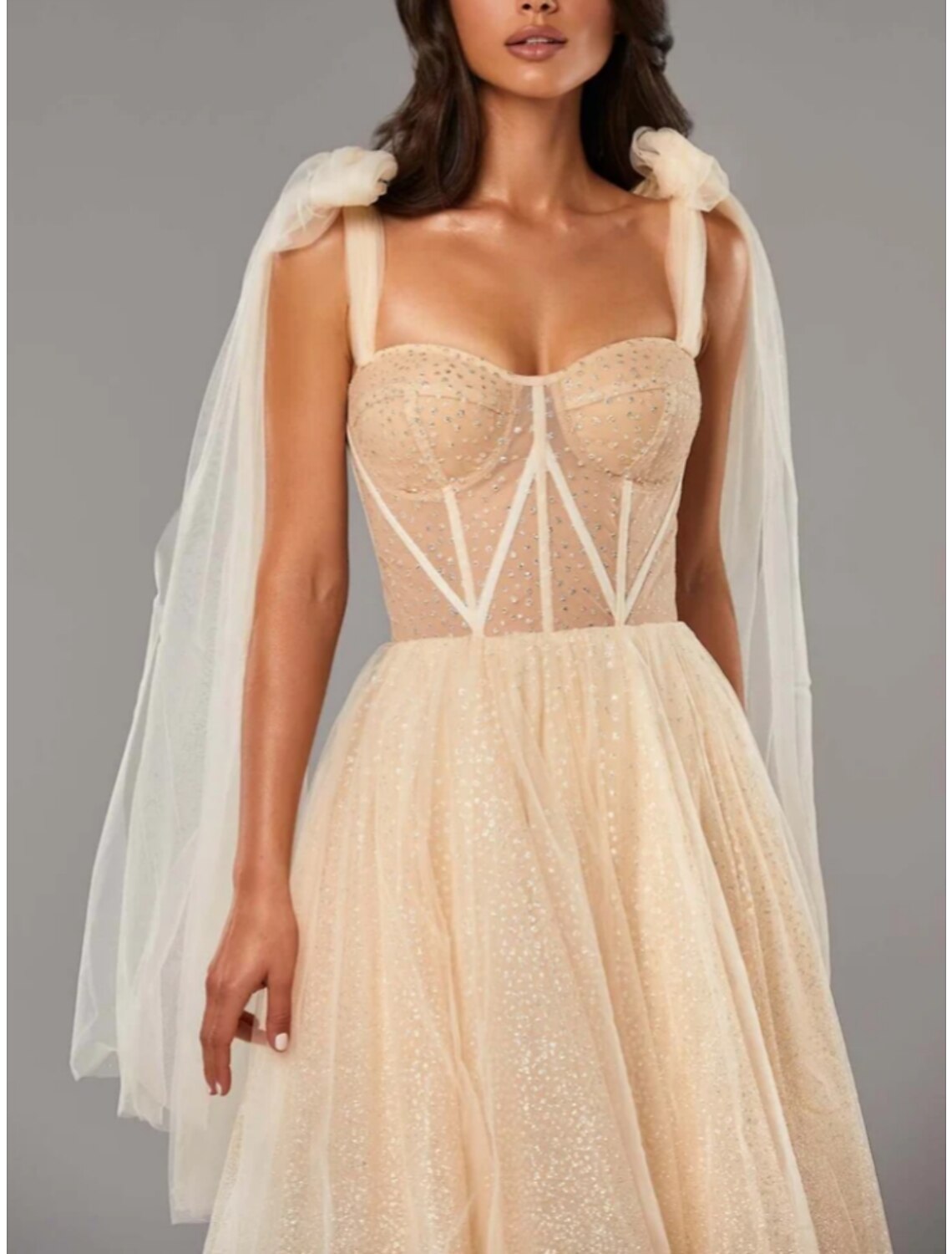 Close-up of the sequin and tulle fabric on an A-line dress.