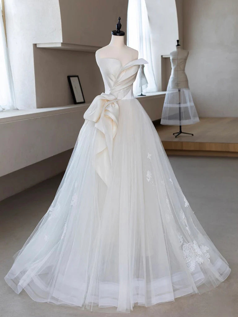 Elegant A-line tulle and lace prom dress on a model.