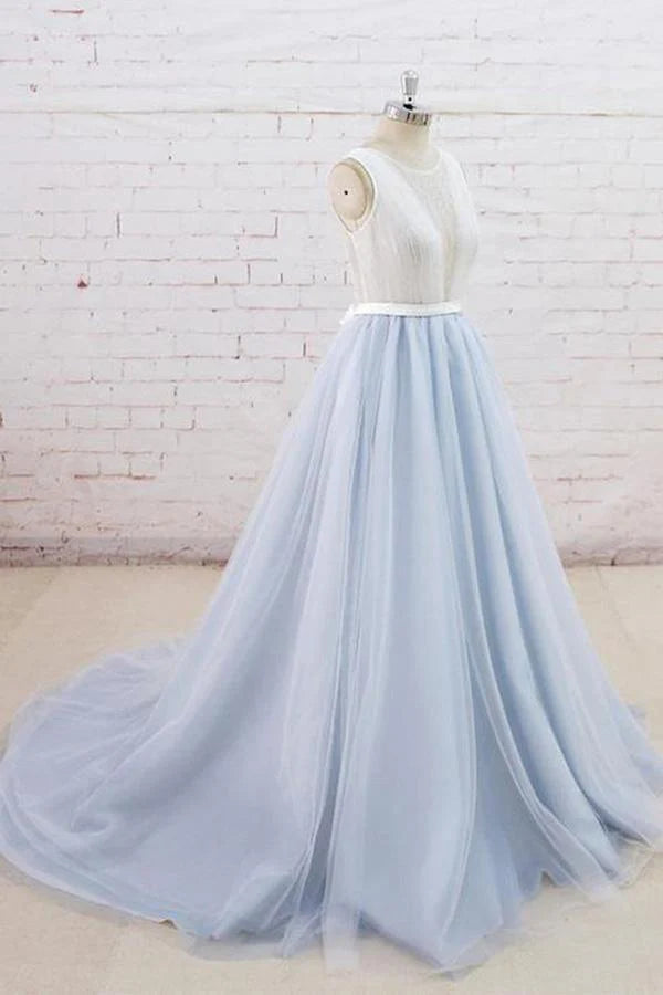 Side profile of the sleeveless tulle gown with a flowing silhouette.