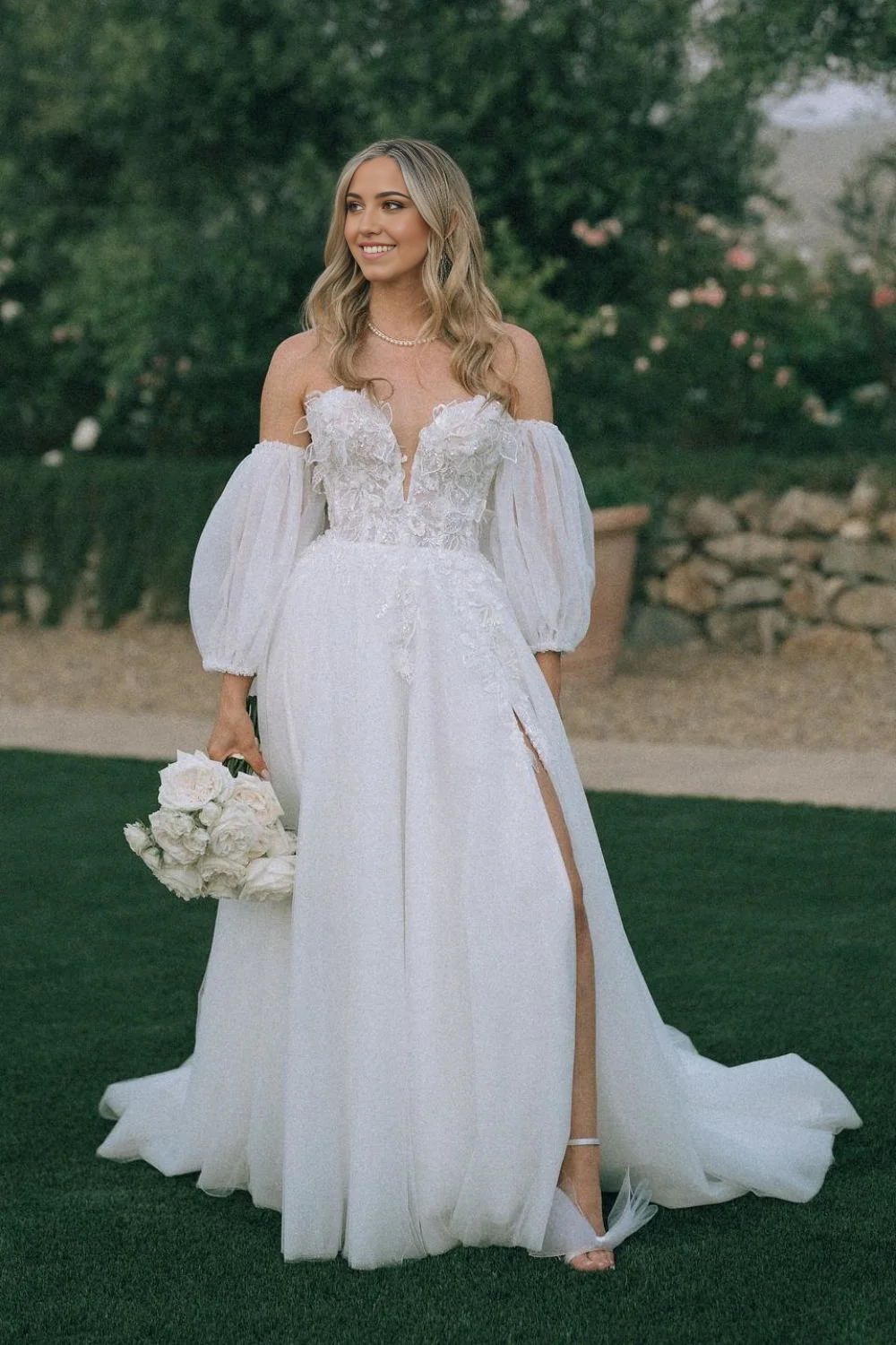 Front view of a white A-line sweetheart wedding dress with delicate appliques.