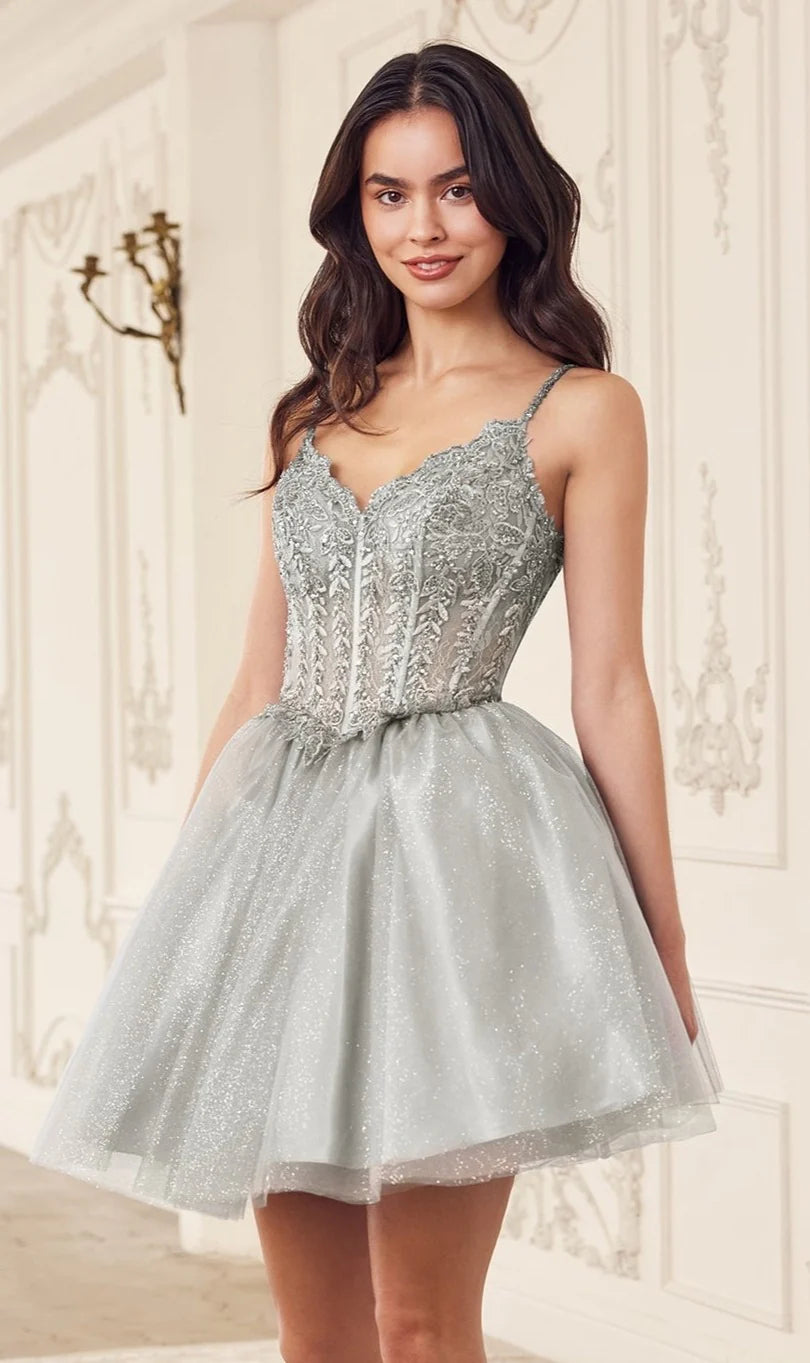 A-Line short homecoming dress with sweetheart neckline, spaghetti straps, lace corset bodice, and glitter tulle skirt.