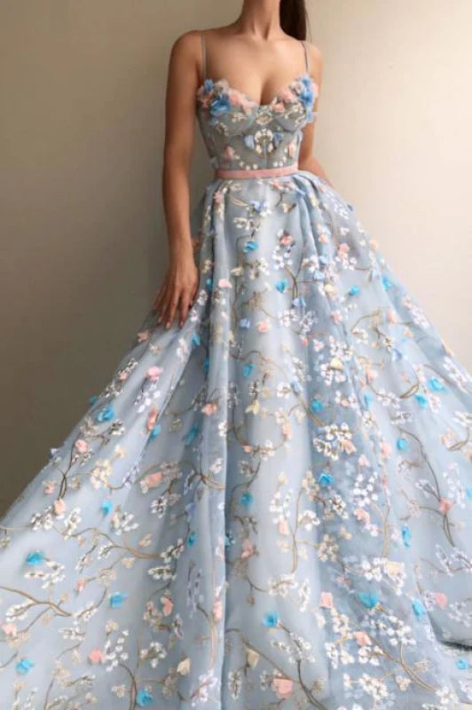 Woman wearing an elegant spaghetti strap sweetheart lace maxi prom dress.