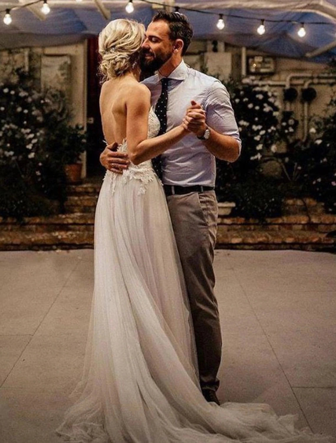 Side view of an A-line wedding dress with delicate lace and sweep train.