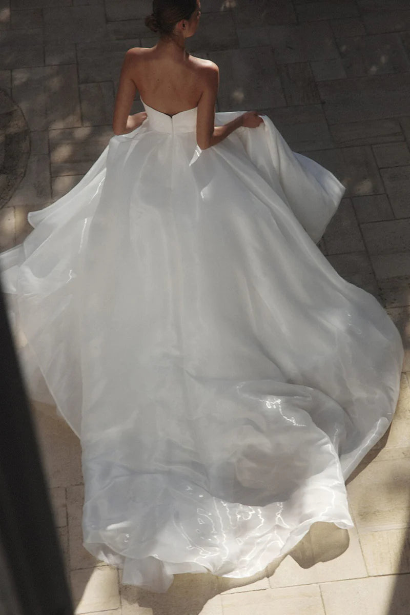 Bridal gown featuring an A-line silhouette, sweetheart top, and leg split.