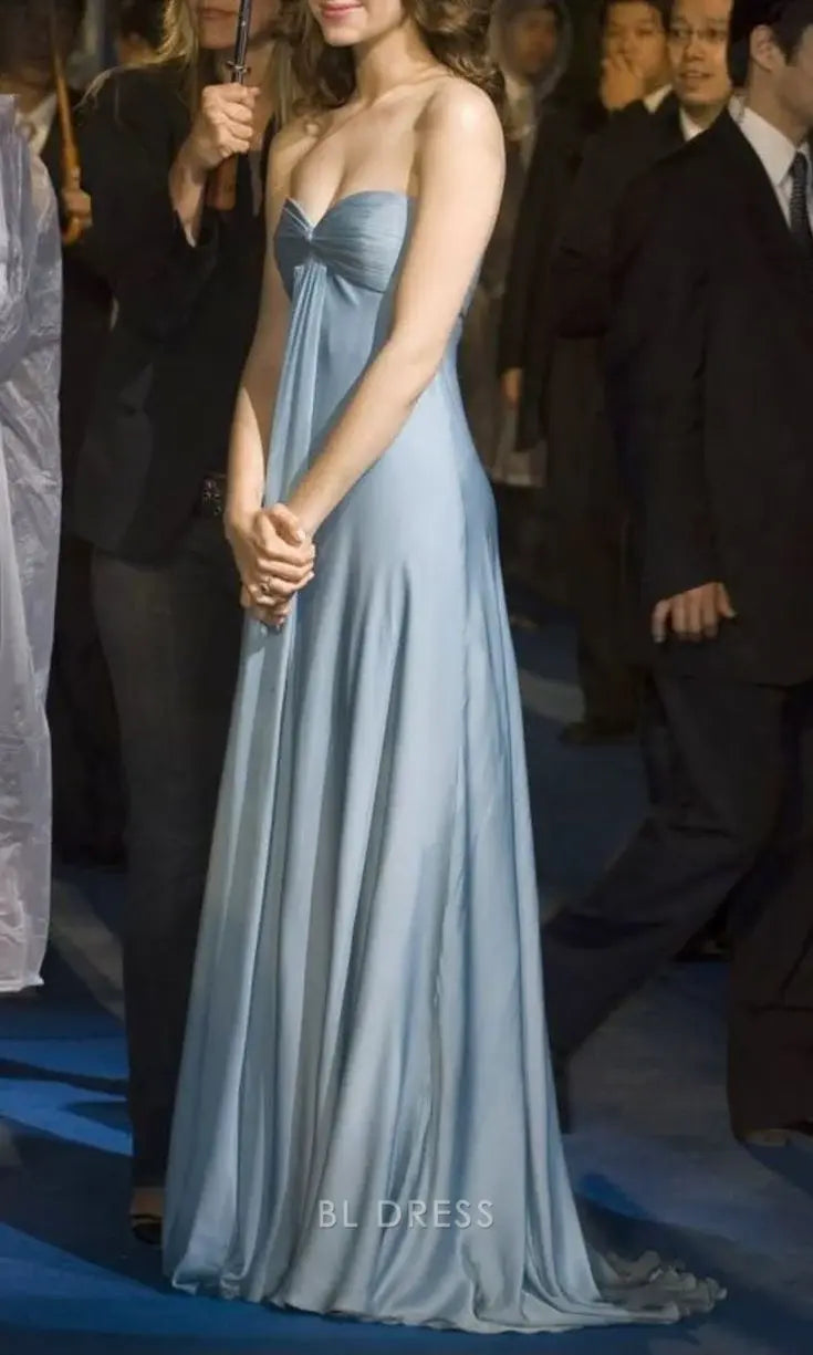 Woman wearing an elegant blue satin A-line sweetheart strapless long formal dress.