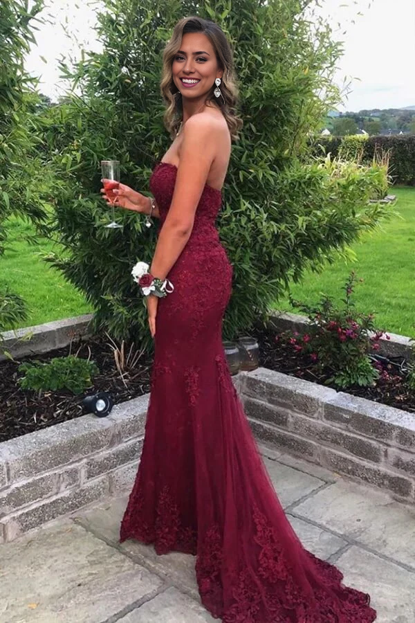 Back view of a woman wearing a sweetheart strapless evening gown.