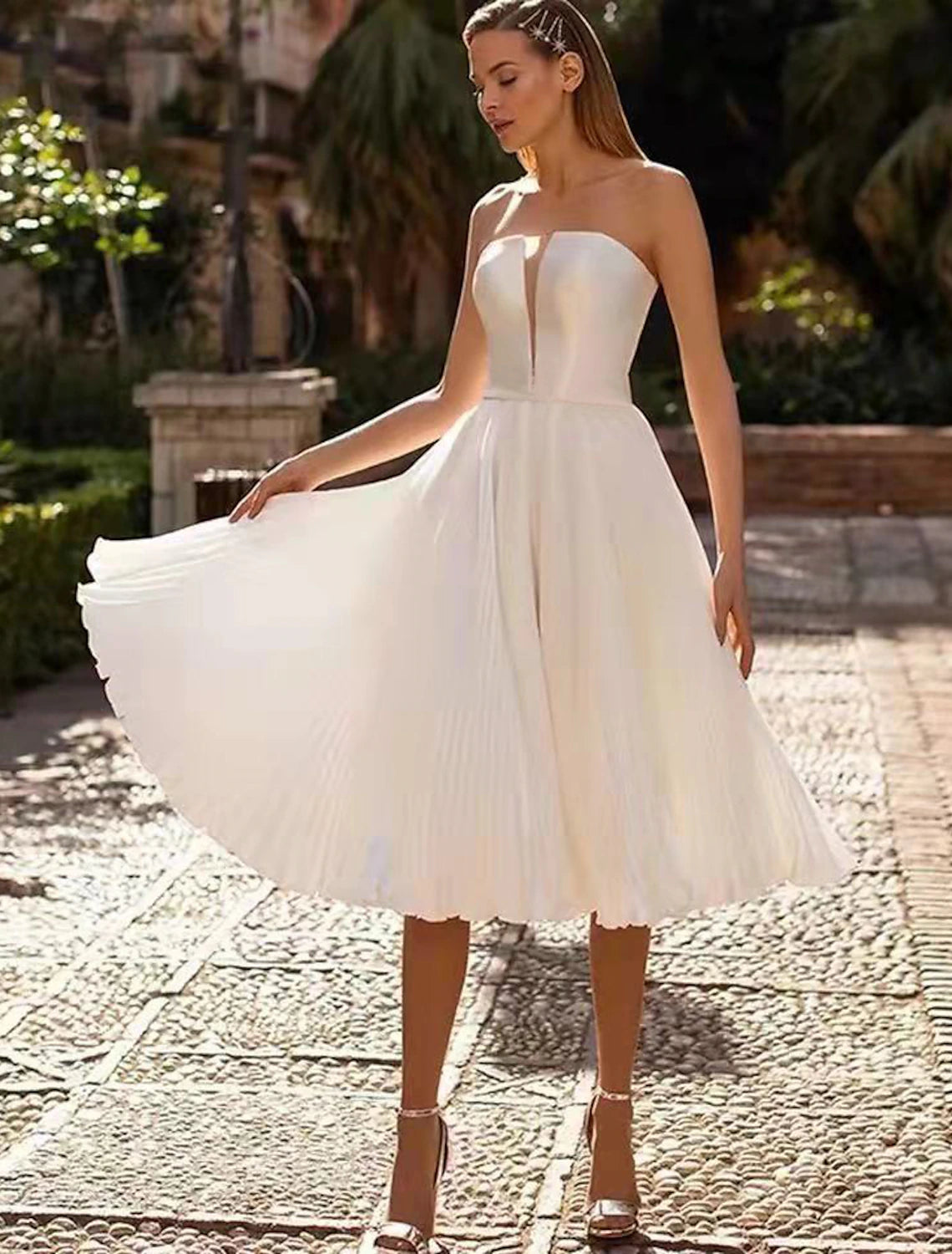 White A-line satin tea length wedding dress with sweetheart neckline.