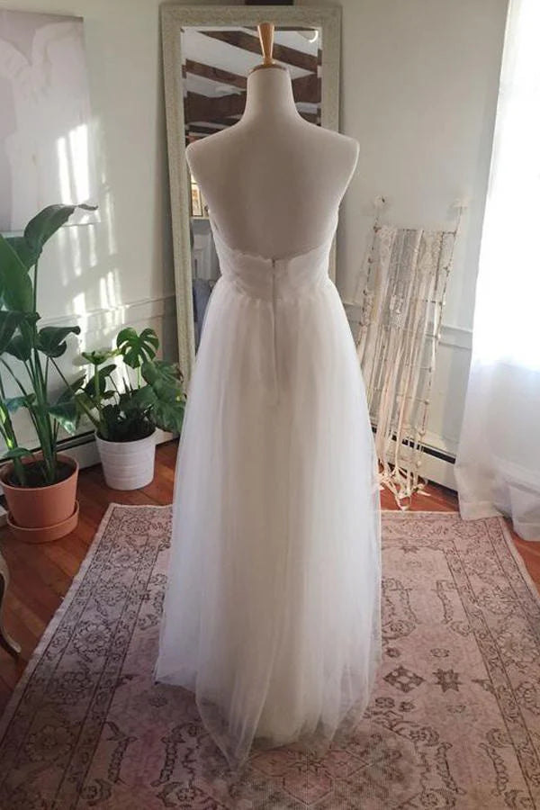 Back view of a bride wearing a floor-length tulle wedding gown.