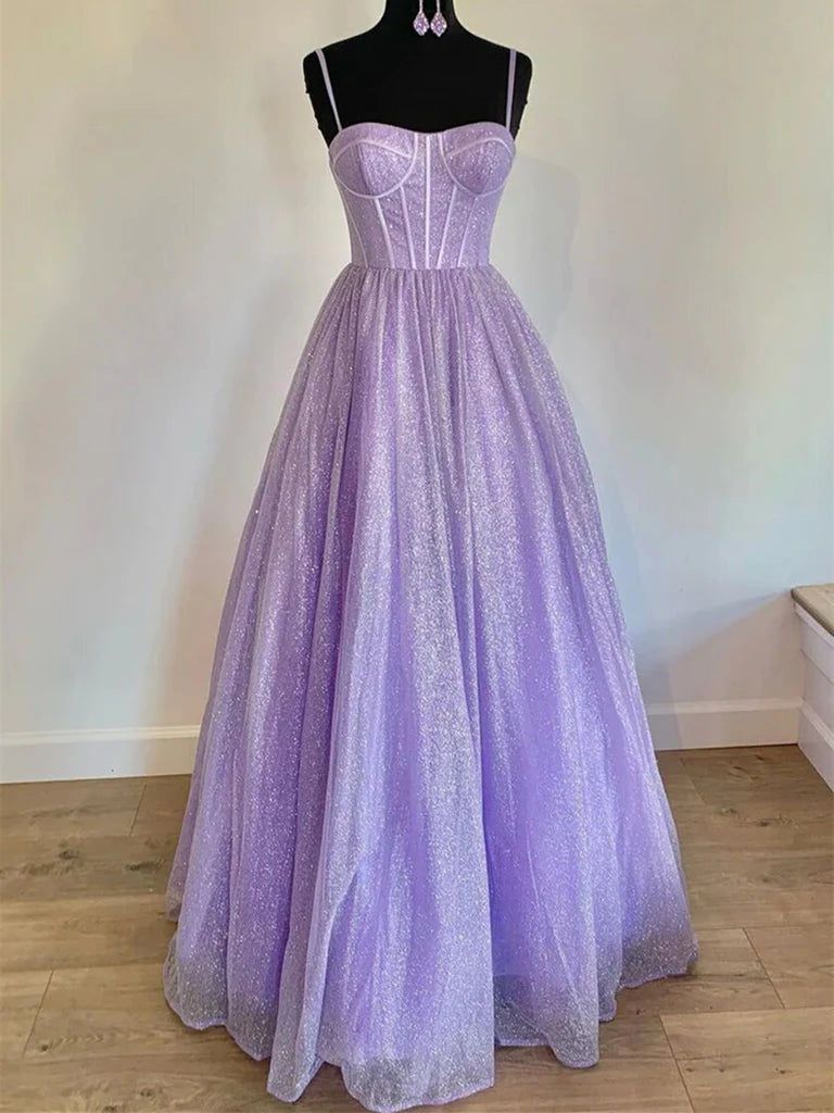 Woman wearing an elegant A-line sweetheart strappy long prom dress.