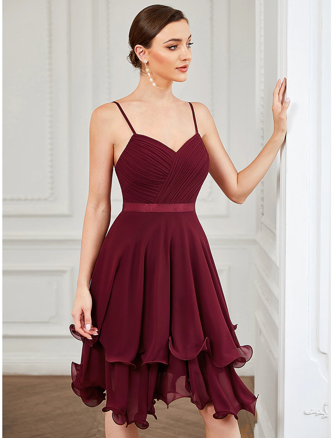 Close-up of the tiered chiffon fabric on the short dress.