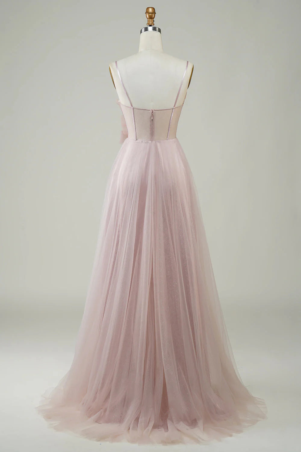 Model wearing blush A-line tulle gown, side view.
