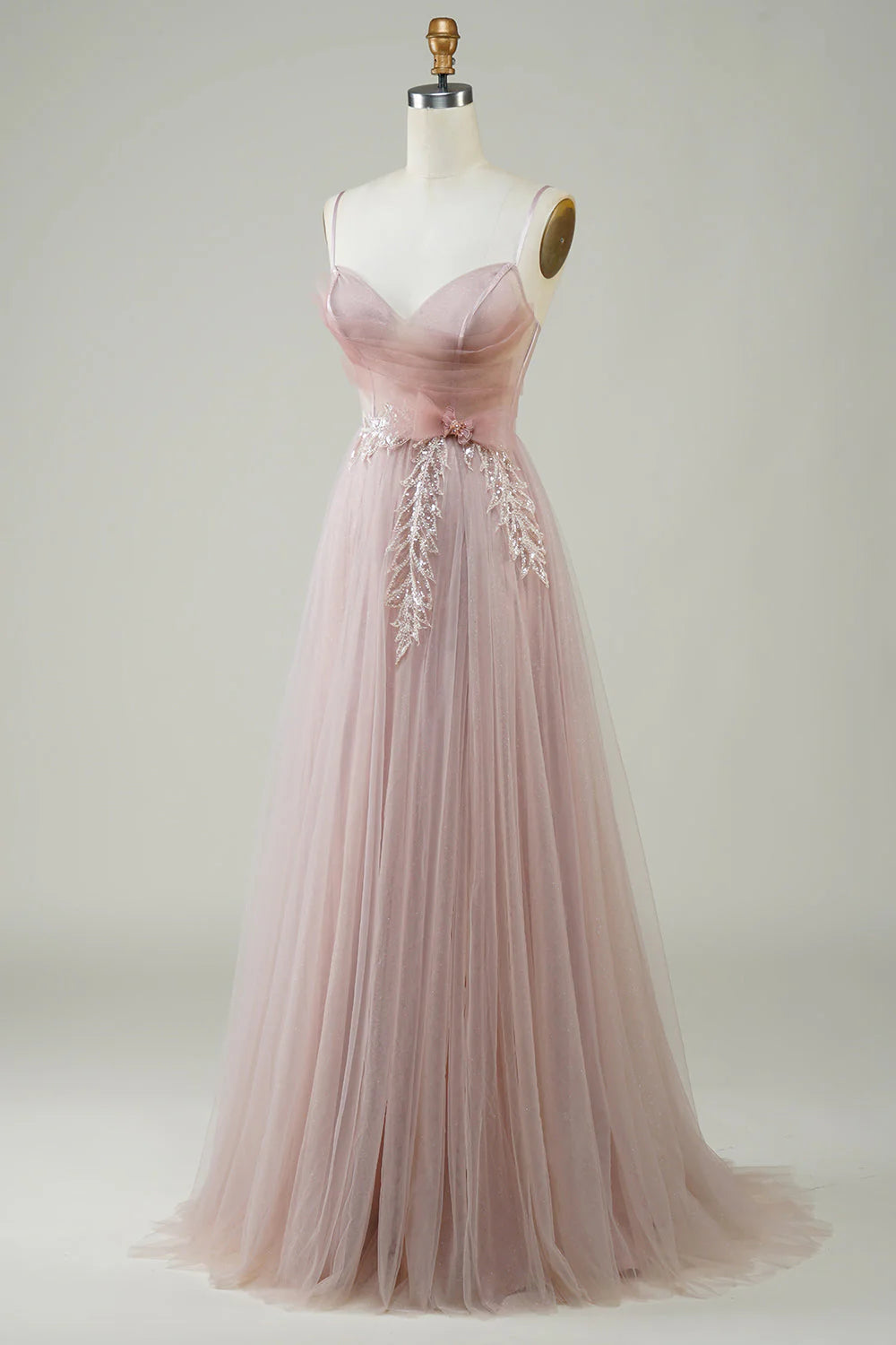 Close-up of appliques on blush corset prom dress.