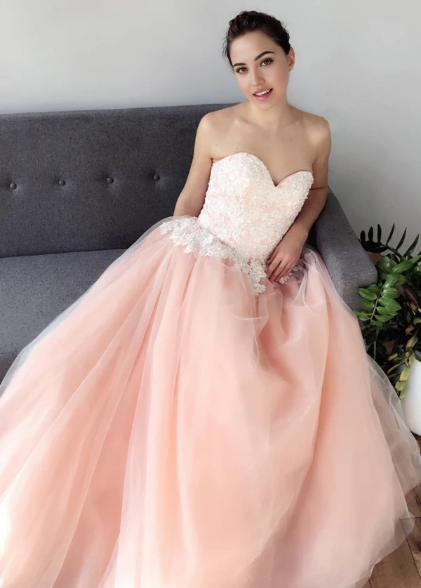 Elegant A-line wedding gown with sweetheart neckline and delicate tulle skirt.