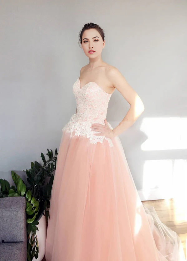 Back view of A-line wedding dress featuring intricate appliques and flowing tulle.