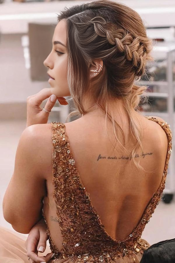 Close-up of the backless design and intricate beaded details on a brown prom dress.