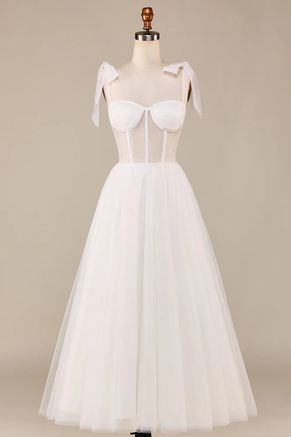 Elegant ivory tulle wedding dress with spaghetti straps and corset bodice.