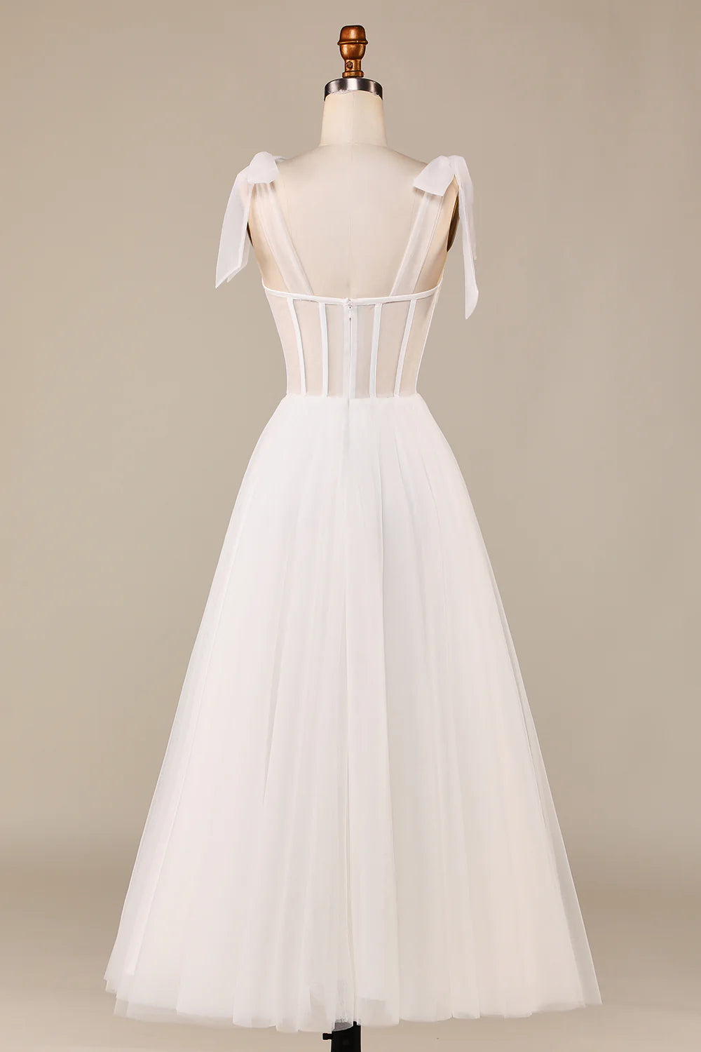 Side view of ivory A-line wedding gown, highlighting tulle skirt.